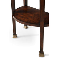 Leg details of mahogany demi lune console, brass feet visible.