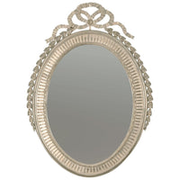Decorative silver gilt oval mirror with intricate top decoration.