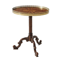 Elegant oval side table with brass gallery.