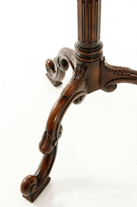 Close-up of table's carved wooden base details.
