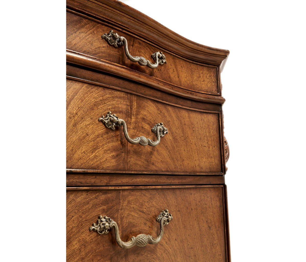 Drawer handles on walnut pedestal desk.