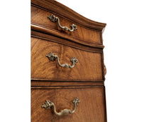 Drawer handles on walnut pedestal desk.