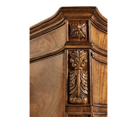 Carved floral detail on walnut desk corner.