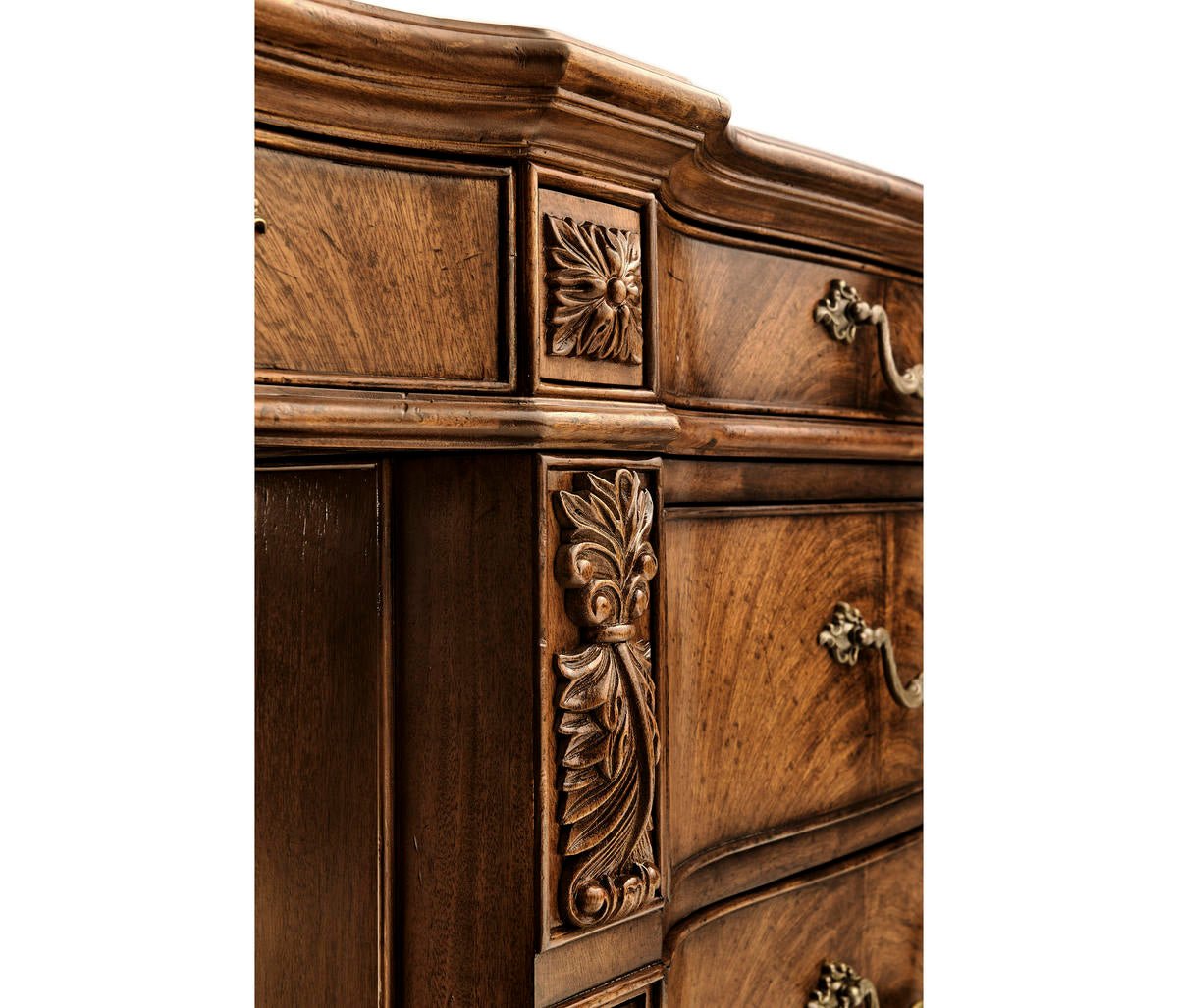 Carved design on side of walnut desk.
