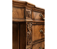 Carved design on side of walnut desk.