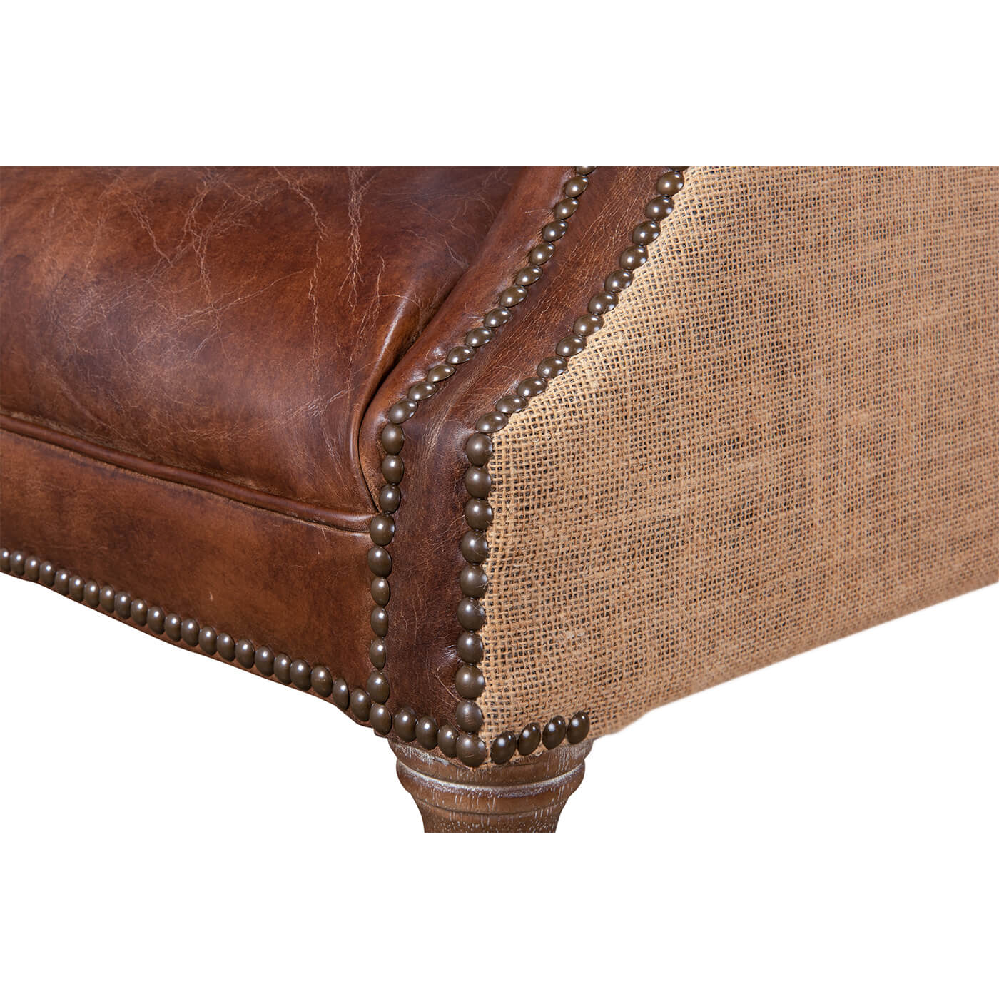 Nailhead trim on barrel chair, close-up.