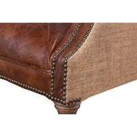 Nailhead trim on barrel chair, close-up.