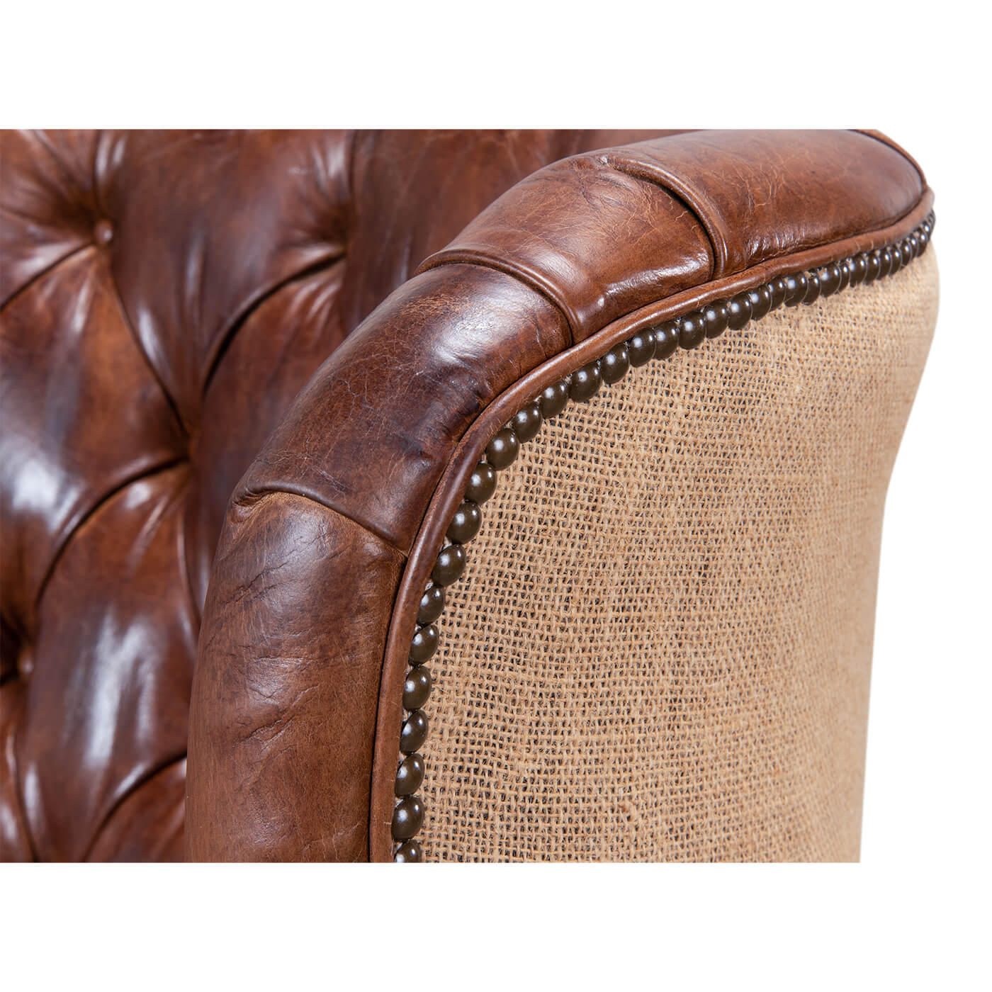 Close-up of barrel chair armrest, leather and jute.