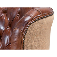 Close-up of barrel chair armrest, leather and jute.