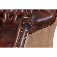 Close-up of chair arm, leather and jute detail.