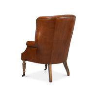 Back view of brown leather wingchair.