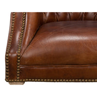 Close-up of leather seat and nailhead details.