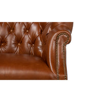 Armrest and nailhead trim detail on wingchair.