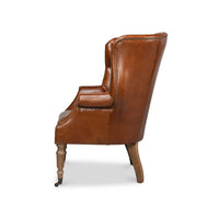 Side profile of brown leather wingchair.