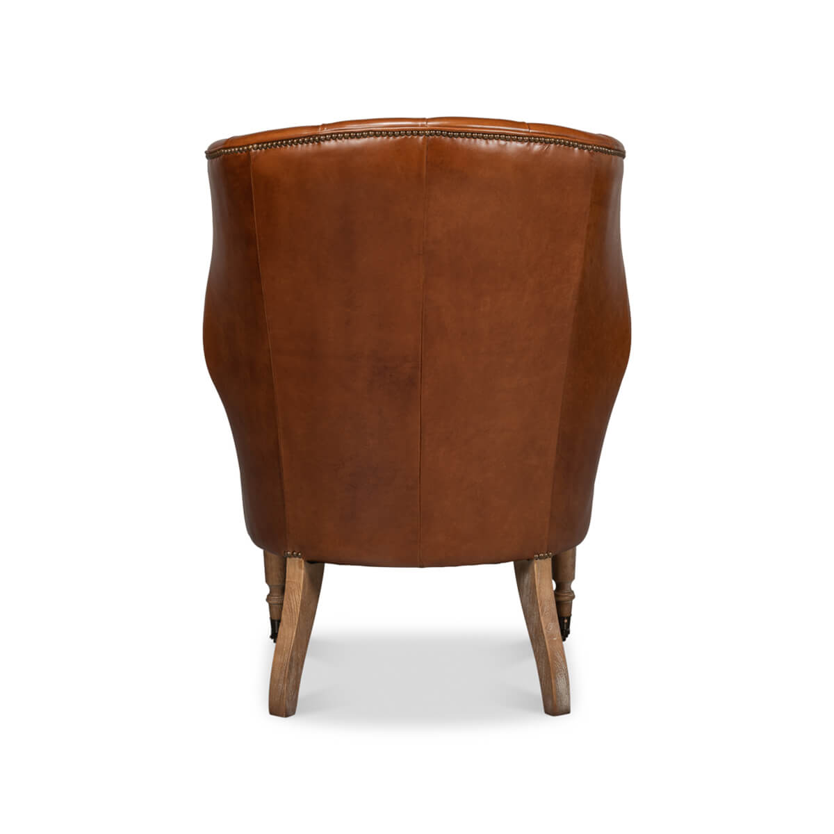 Back view of leather wingchair with wood legs.