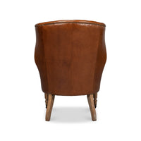 Back view of leather wingchair with wood legs.