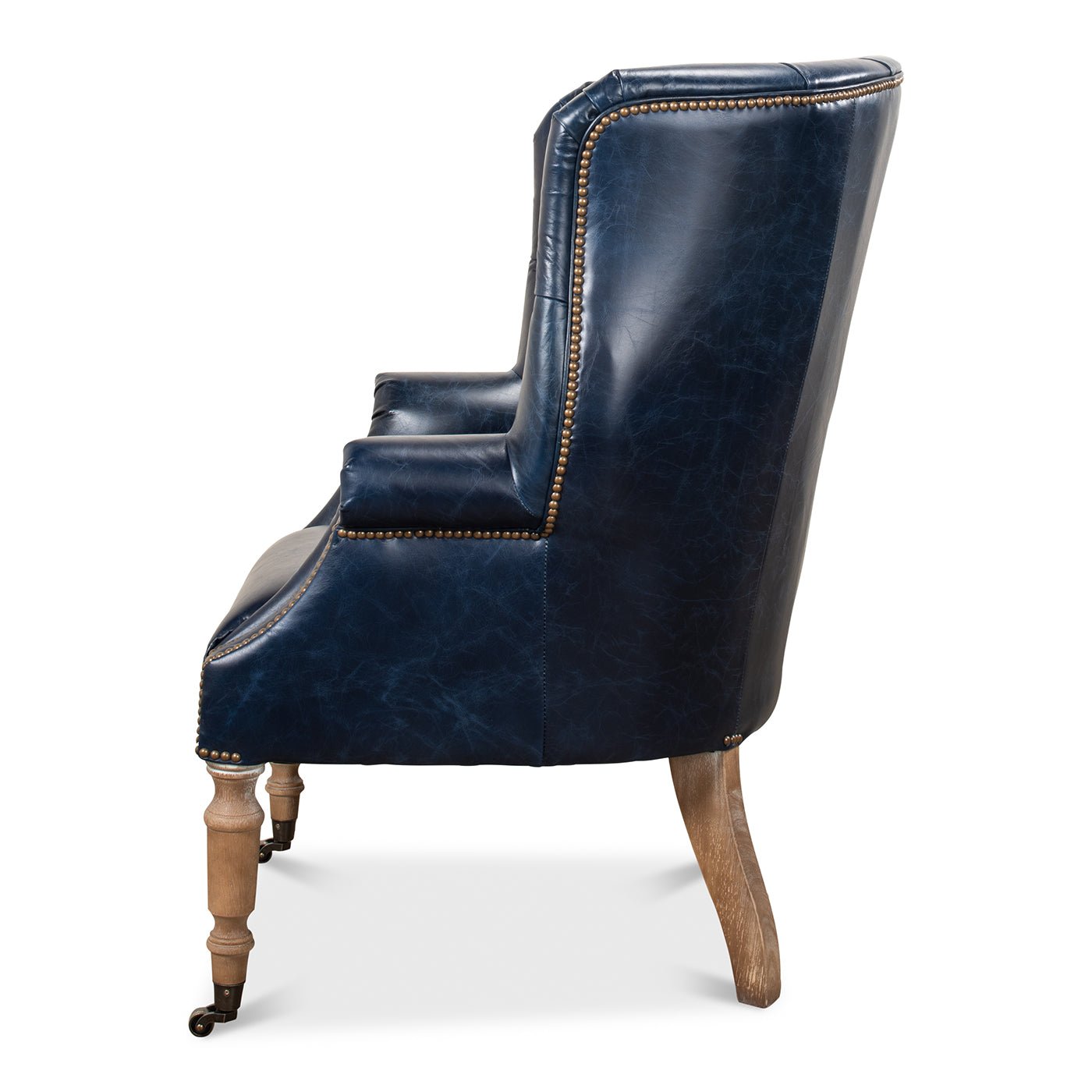 Side view of blue wingchair showing armrest and legs.