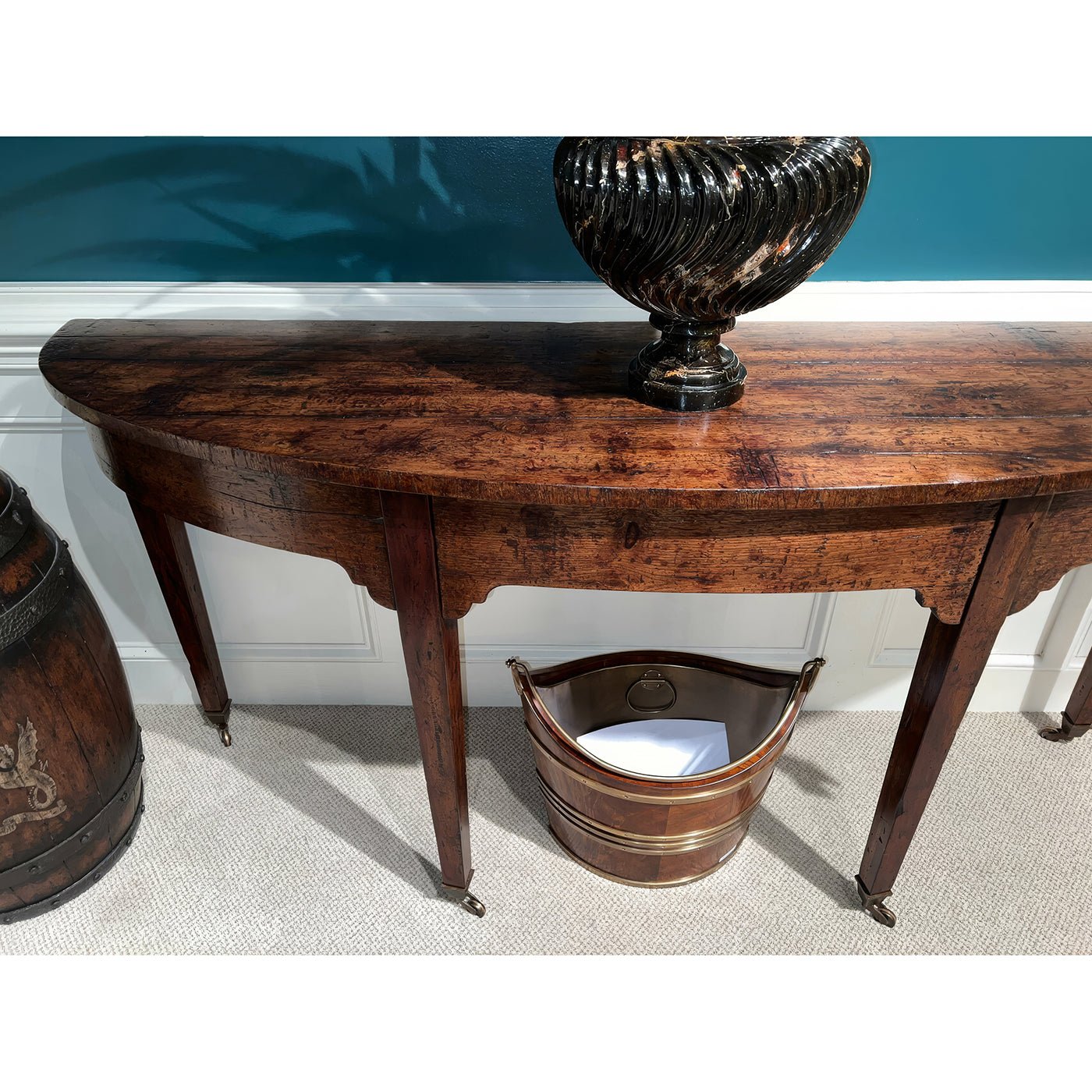 Georgian bowfront console table with decorative items underneath.