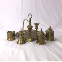 Brass inkwell set, components removed, on white background.
