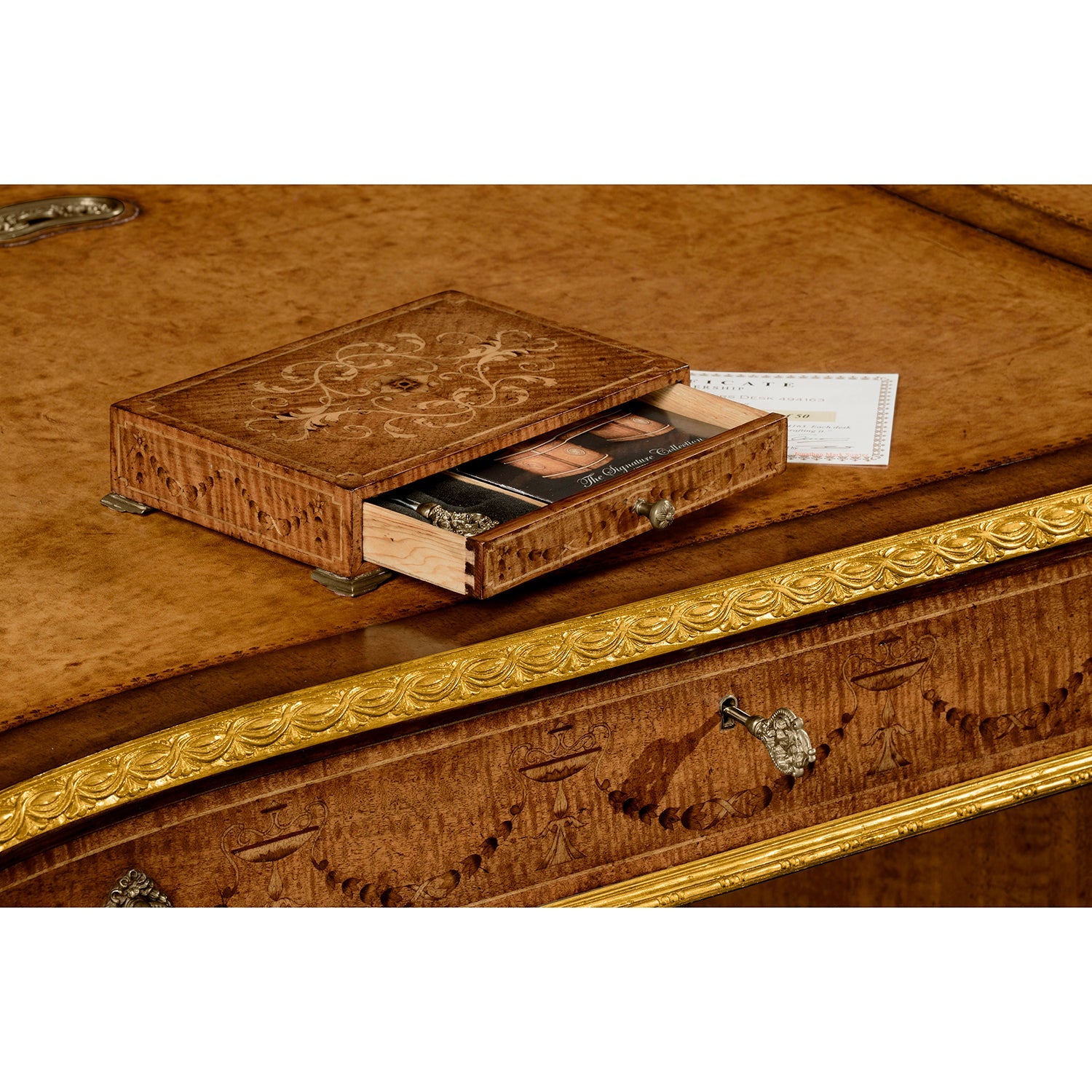 Close view of Georgian desk's drawer with decorative carvings.
