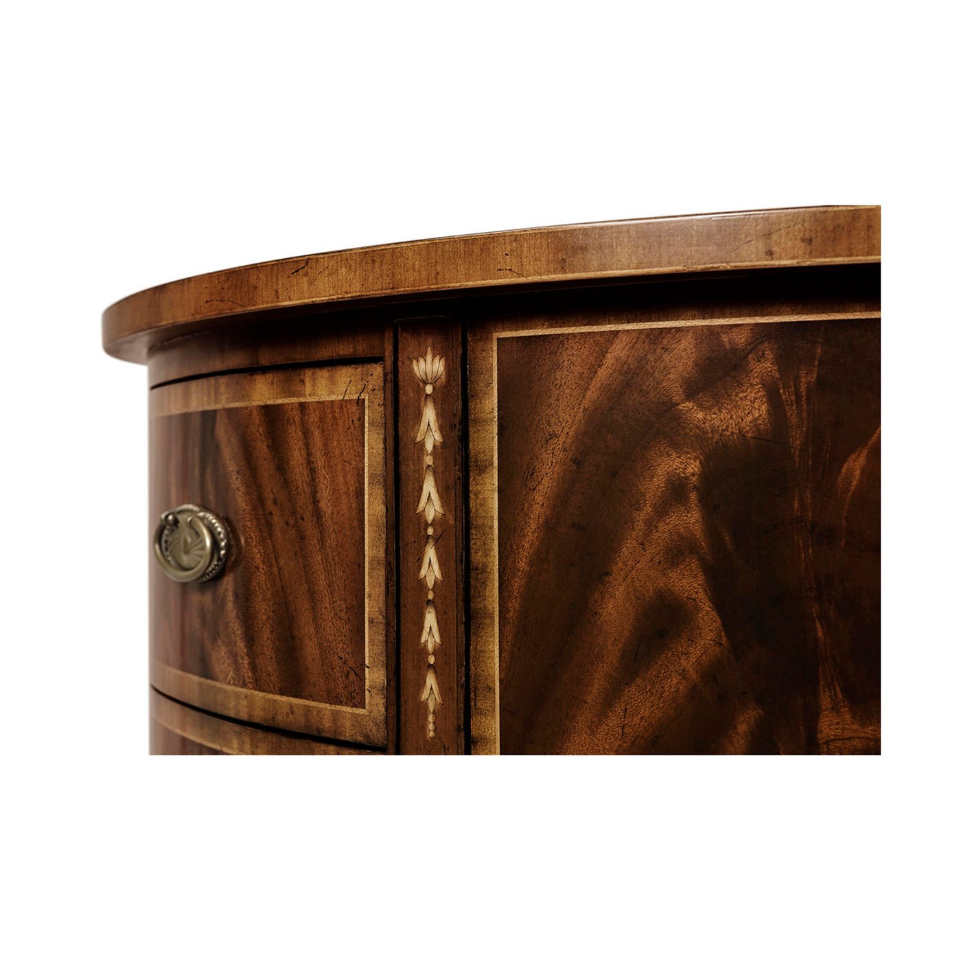 Detailed side panel on mahogany demilune chest of drawers.