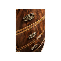 Close-up of drawer handles on demilune chest of drawers.