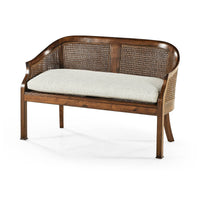 Wooden bench with cane backrest and cushion, front angle.