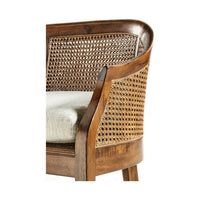 Close-up of wooden bench cane backrest and cushion.