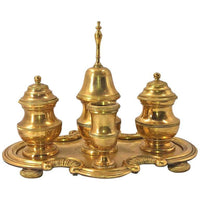 Gilt bronze desk set with lids and central bell.