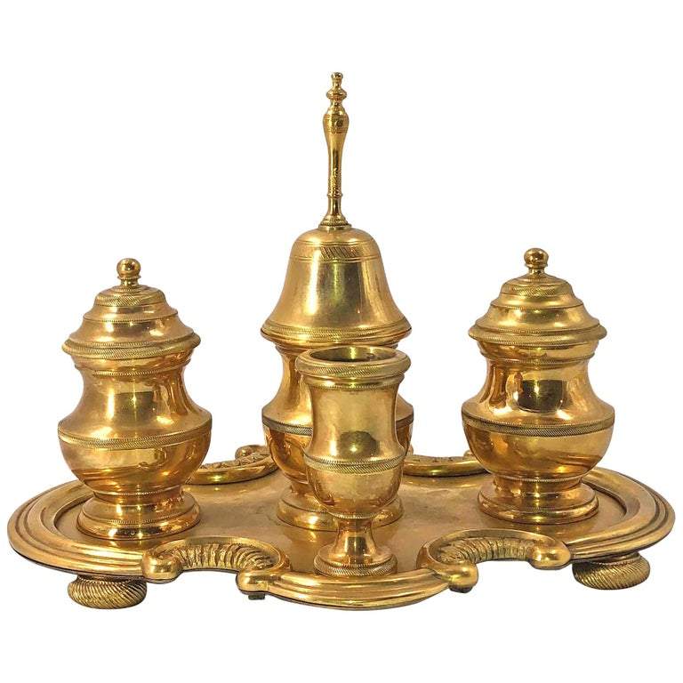 Gilt bronze desk set with lids and central bell.