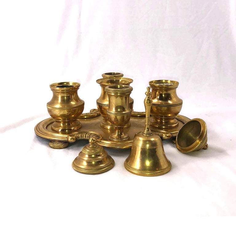 Gilt bronze desk set components, lids removed, on display.