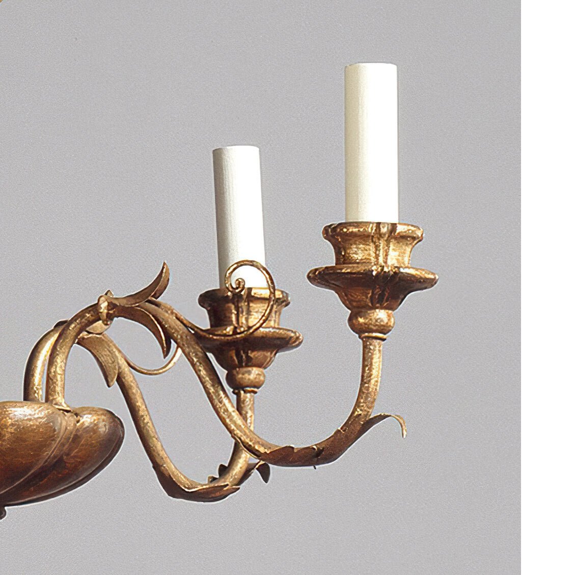 Close-up of two candle-style lights on chandelier.