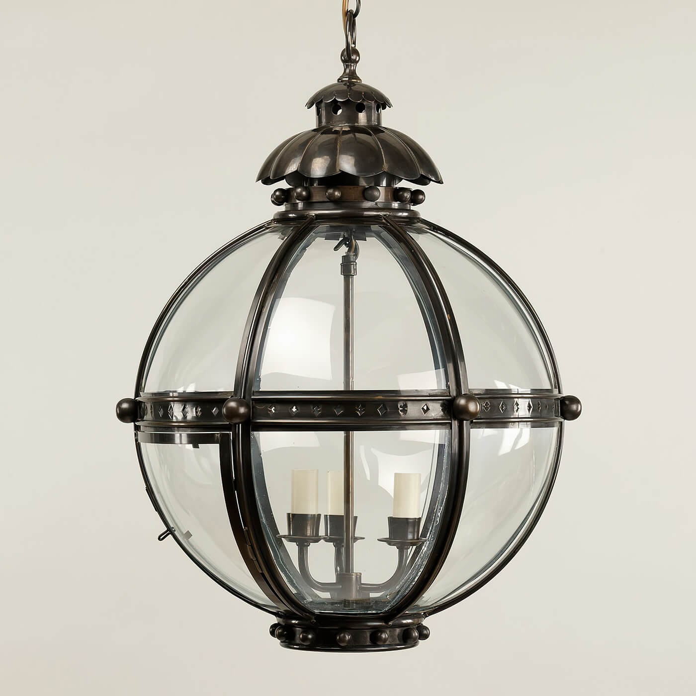 Bronze globe lantern, clear view, neutral background.