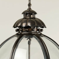 Top detail of bronze globe lantern, close-up.