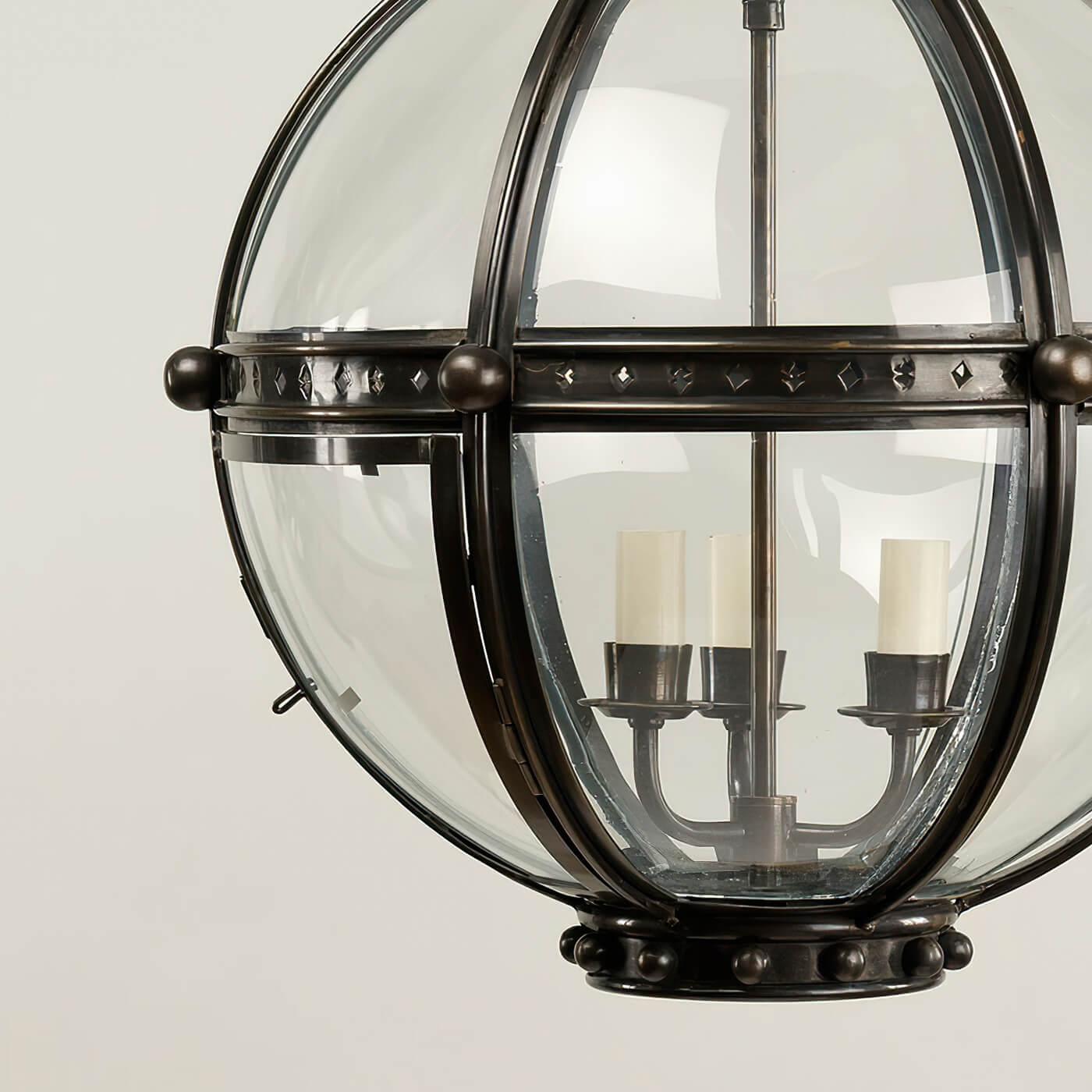 Base view of bronze globe lantern, candle-style bulbs.