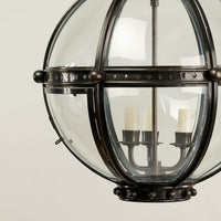 Base view of bronze globe lantern, candle-style bulbs.