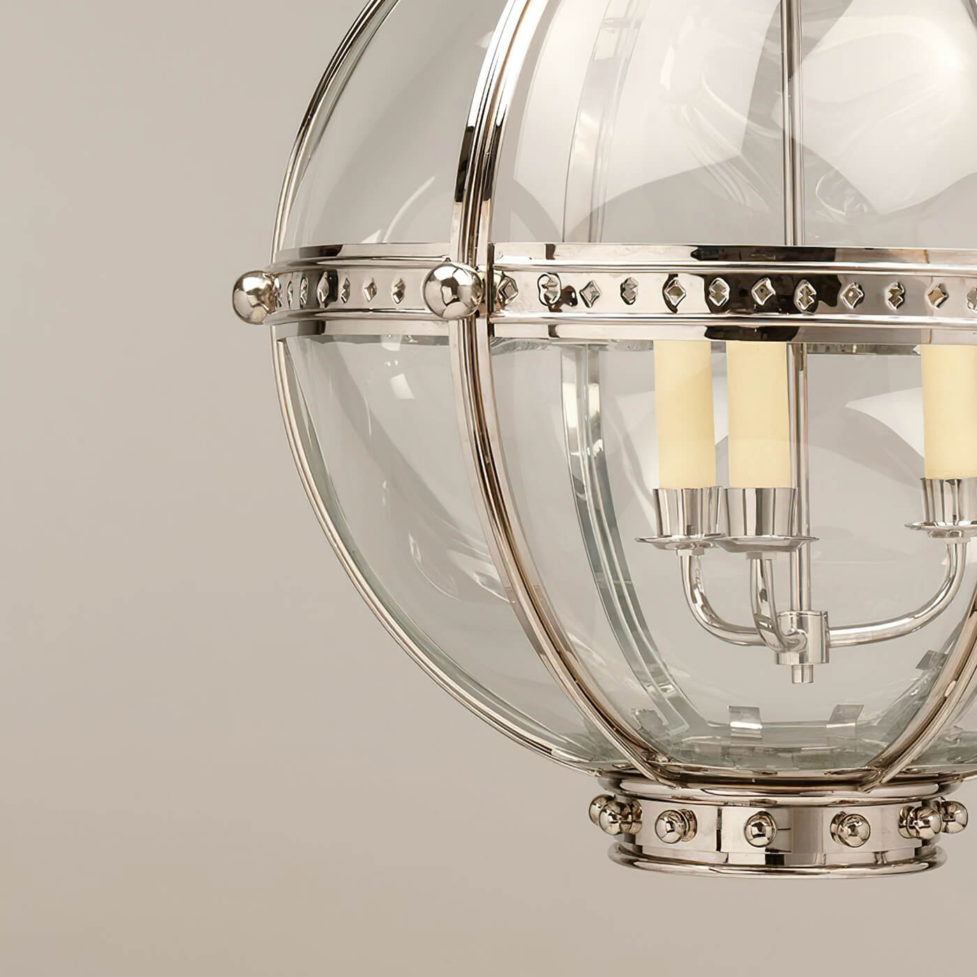 Close-up of globe lantern with three lights.