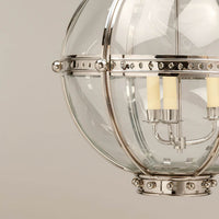 Close-up of globe lantern with three lights.