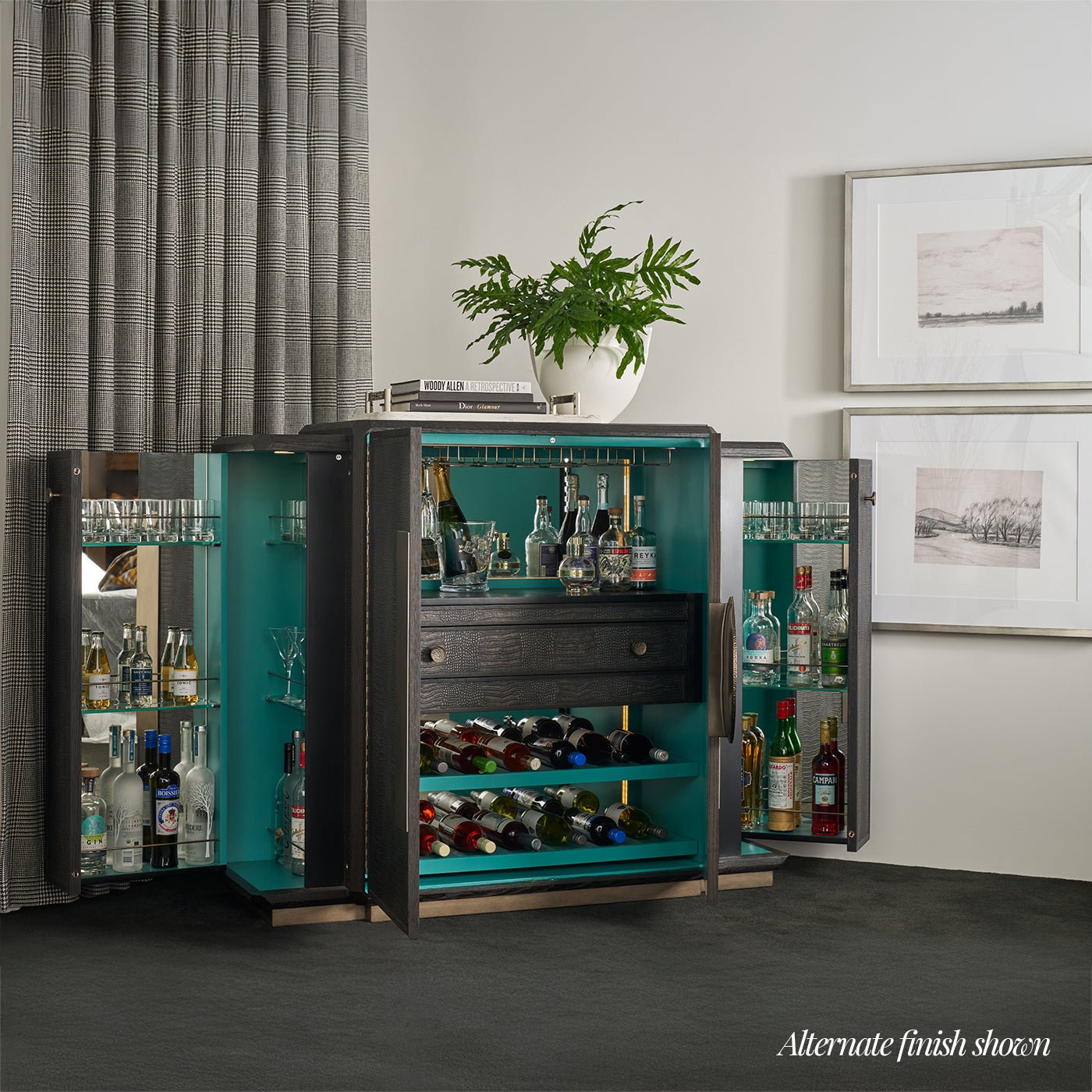 Bar cabinet open, displaying liquor bottles and glasses.