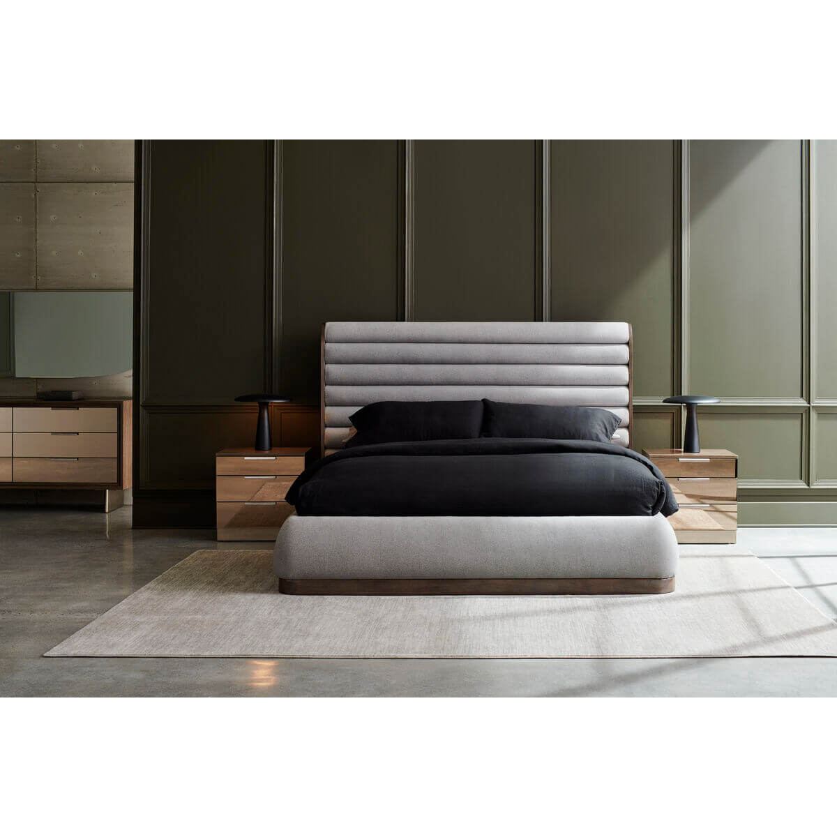 Styled gray channeled king bed in elegant bedroom setting.