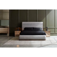 Styled gray channeled king bed in elegant bedroom setting.