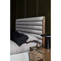Close-up of the gray channeled king bed headboard.