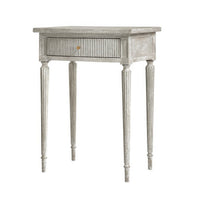 Gray Gustavian side table with fluted drawer detail.