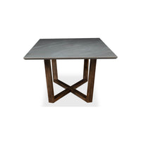 End view of gray porcelain dining table, geometric base.