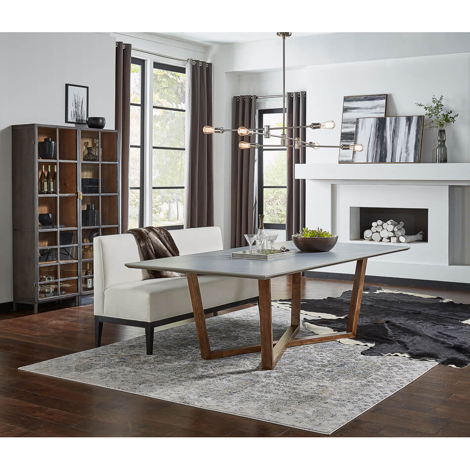 Gray porcelain dining table in styled living room setting.