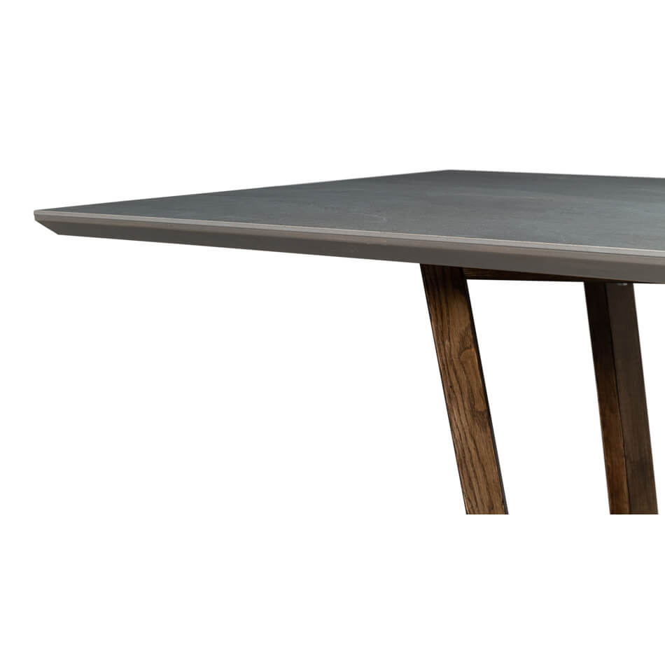 Edge detail of gray porcelain dining table, wooden support.