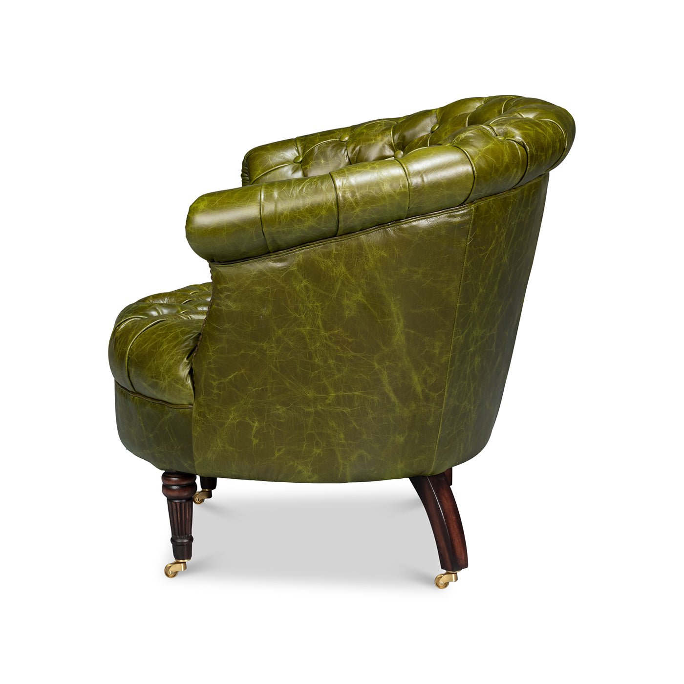 Green leather barrel back chair, side view.
