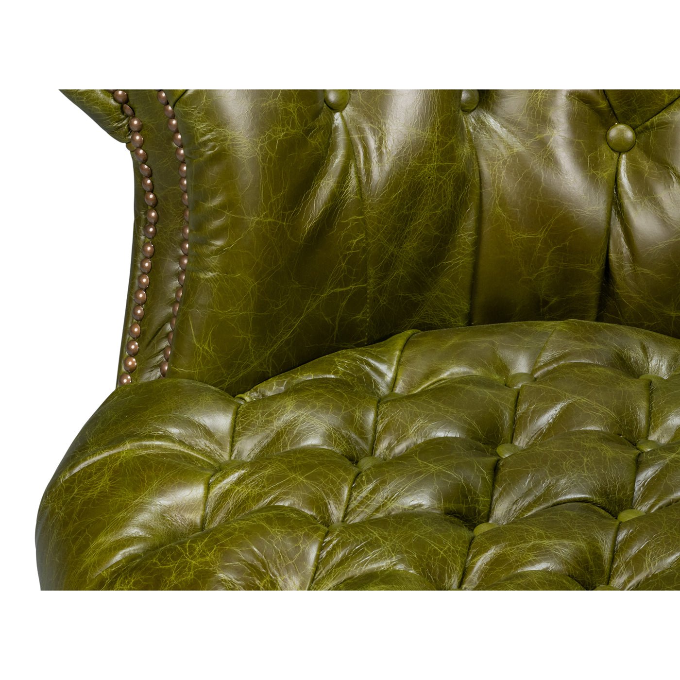 Green leather barrel back chair, seat tufting detail.
