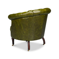 Green leather barrel back chair, back angled view.