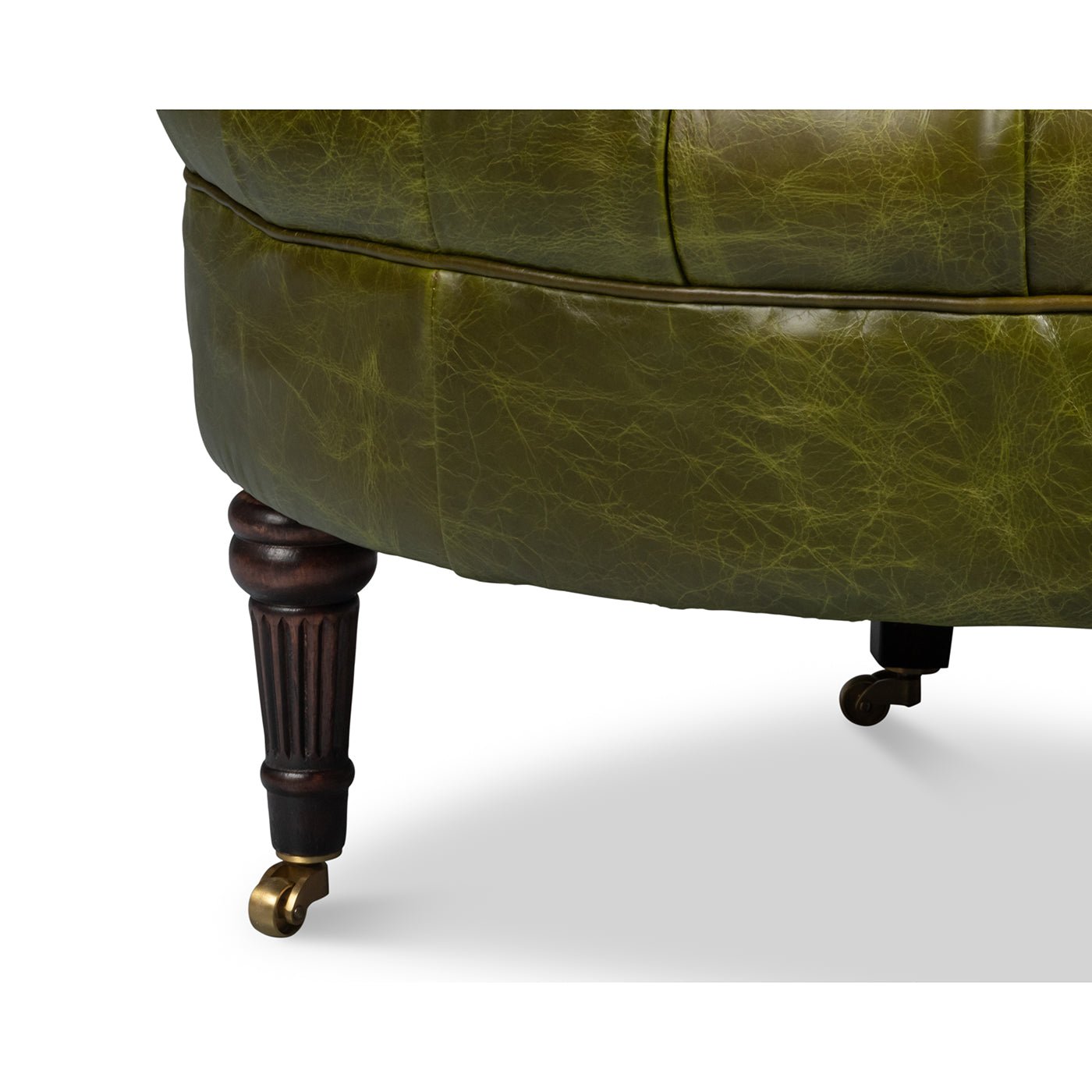 Green leather barrel back chair, front leg with caster.